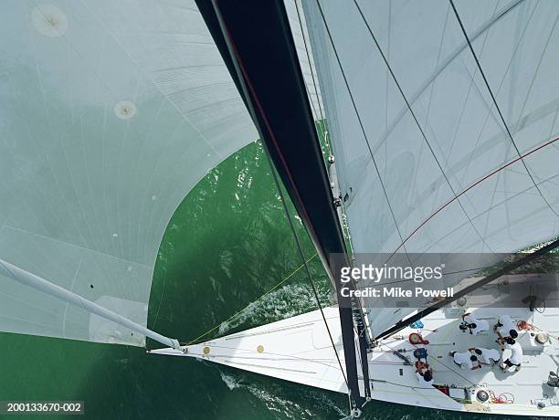 crew working on deck of sailing ocean going racing yacht - yacht club stock pictures, royalty-free photos & images