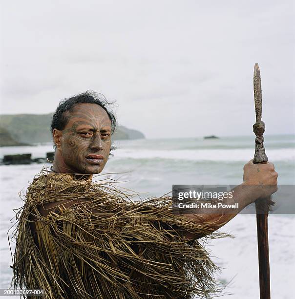 maori warror wearing  cloak, holding taiaha, portrait - maori stock-fotos und bilder