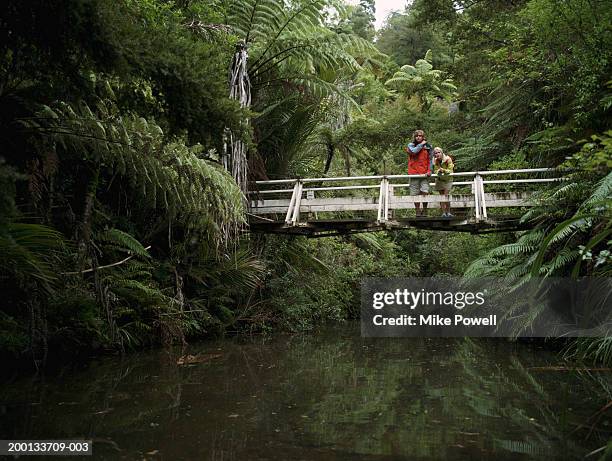 young couple standing on bridge - rope bridge stock pictures, royalty-free photos & images