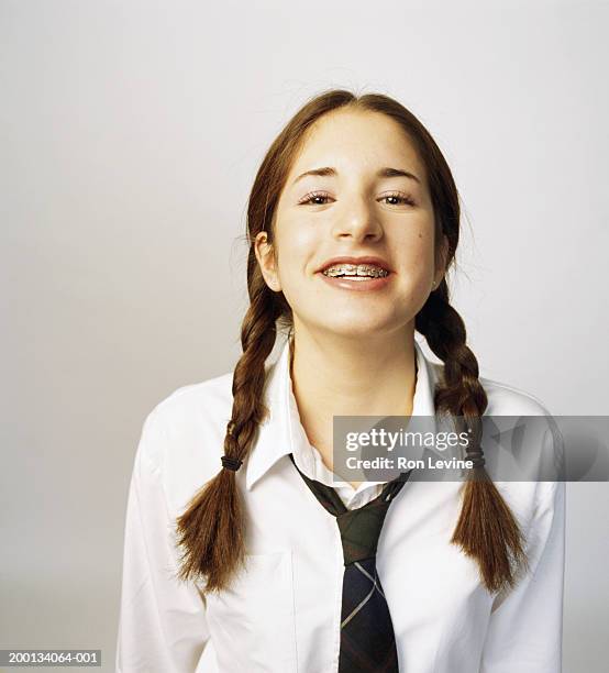 girl (12-14) wearing orthodontic braces, portrait - 12 13 jahre stock-fotos und bilder