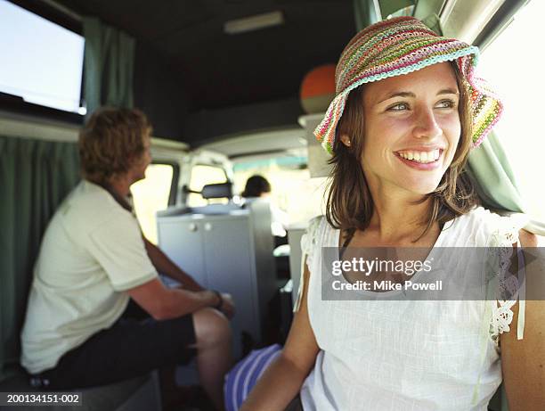 group of friends inside camper van, woman sitting in foreground - van front view stock pictures, royalty-free photos & images