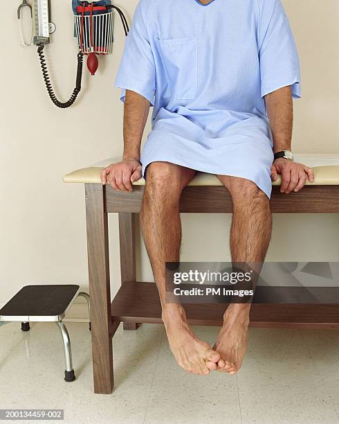 male patient sitting on examining room table, mid section - examining table stock pictures, royalty-free photos & images