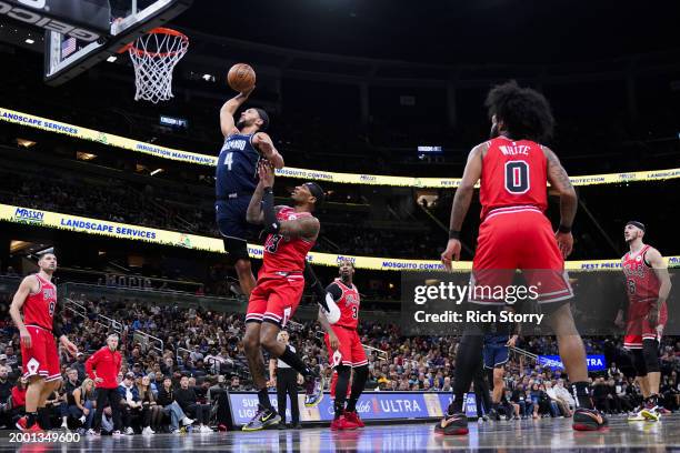 Jalen Suggs of the Orlando Magic dunks the ball over Torrey Craig of the Chicago Bulls during the first quarter at Kia Center on February 10, 2024 in...