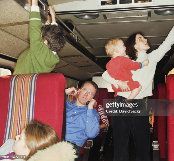 man using mobile phone on busy train - provocation bildbanksfoton och bilder