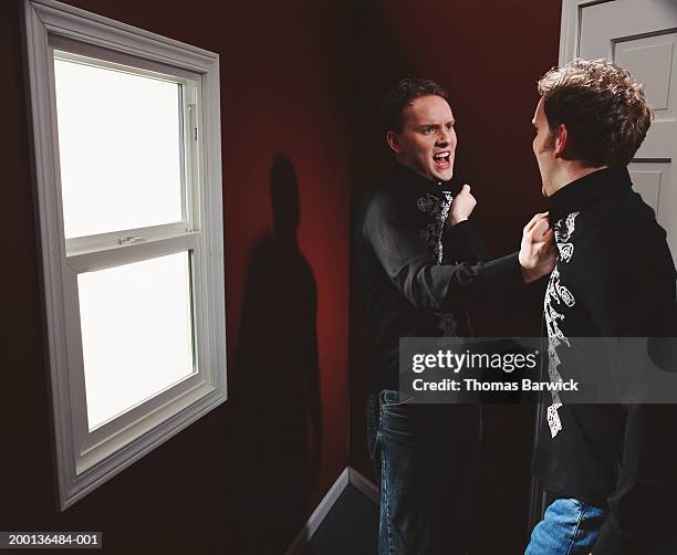 two men face to face, grabbing each other's shirt collar - collar up imagens e fotografias de stock