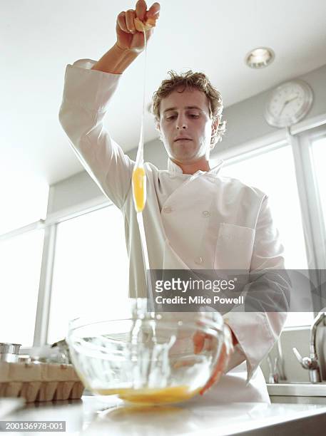 chef  breaking egg over bowl - 2005 20 stock pictures, royalty-free photos & images