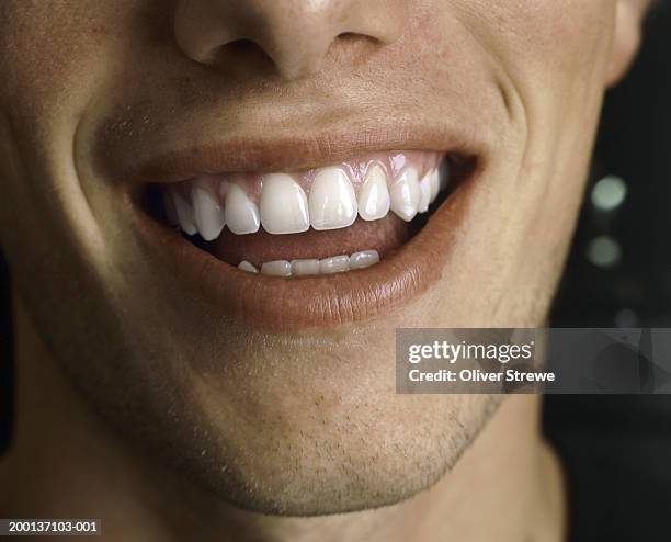 man's smile, close up - toothy smile stock-fotos und bilder