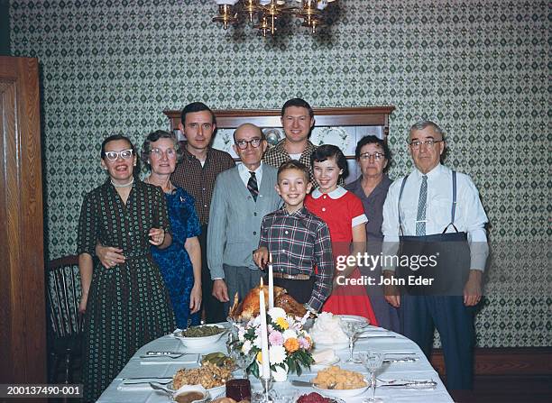 three generational family by thanksgiving dinner table, portrait - 1950s style foto e immagini stock