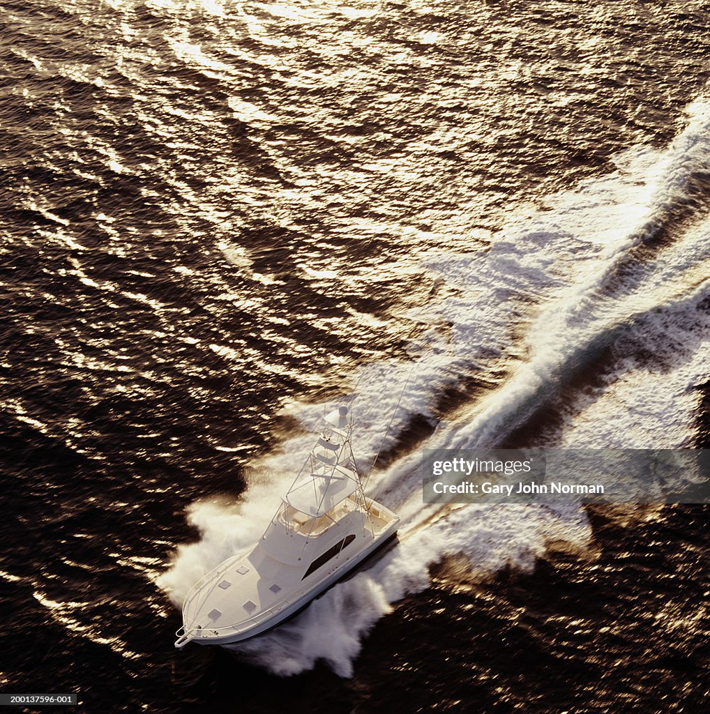 Deep water sport fishing boat leaving wake, aerial view