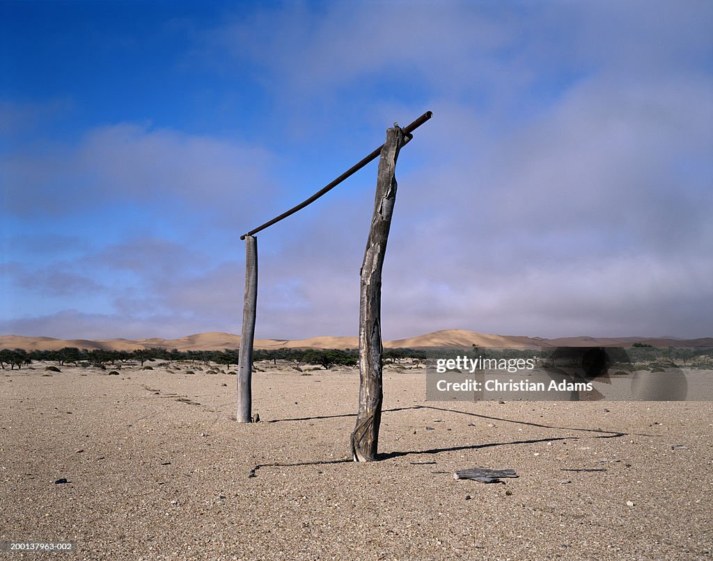Makeshift soccer goal post in desert landscape