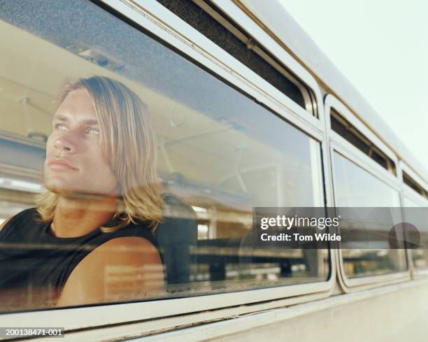 young man on bus, view through window - car top view photos et images de collection