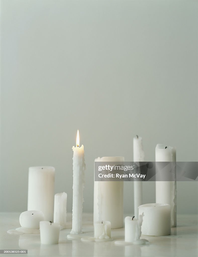 Group of candles, one candle burning