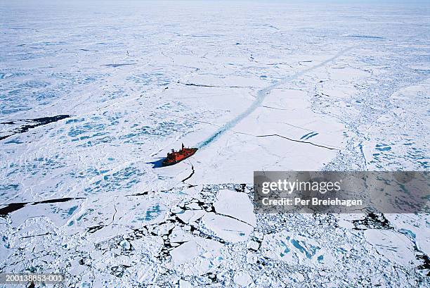 russian nuclear icebreaker clearing path to north pole, aerial view - arctic images stock-fotos und bilder