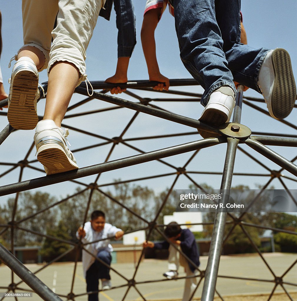 Group of children (9-11) climbing jungle gym