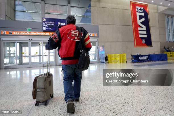 San Francisco 49er fan makes their way inside Harry Reid International Airport ahead of Super Bowl LVIII on February 10, 2024 in Las Vegas, Nevada.