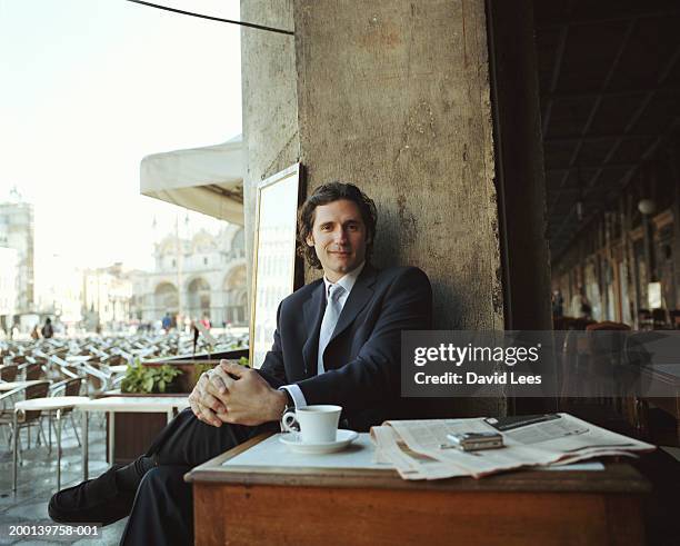 businessman sitting in cafe, portrait - business suit tie stock-fotos und bilder