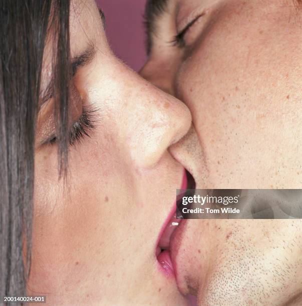 young couple kissing, close-up - pecking stock pictures, royalty-free photos & images