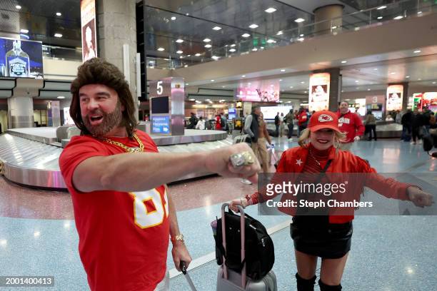 Jeff and Courtney Ravsik of Denver, dressed as Travis Kelce of the Kansas City Chiefs and Taylor Swift, greet other fans inside Harry Reid...