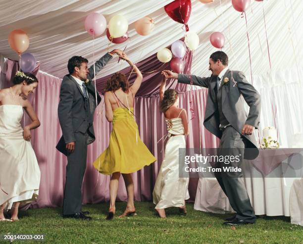 bridal party dancing in marquee - tail coat stock pictures, royalty-free photos & images