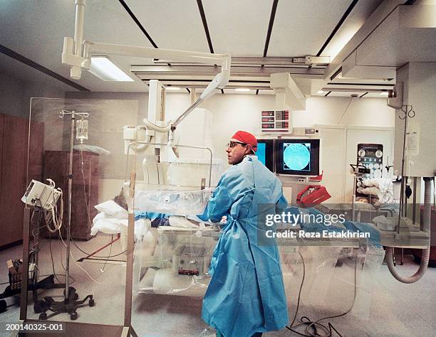 doctor making preparations for angioplasty surgery - angioplasty stock pictures, royalty-free photos & images