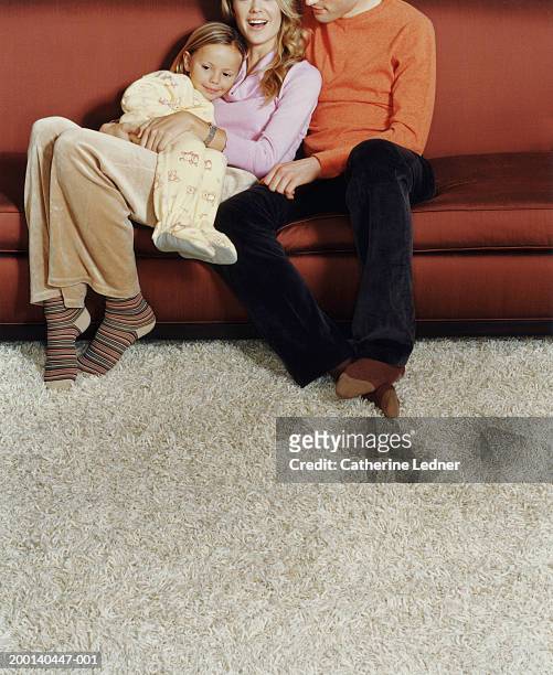 family in living room, girl (3-5) sitting on mother's lap - shag stock pictures, royalty-free photos & images