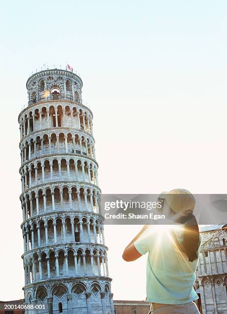 italy, tuscany, pisa, woman taking photo of leaning tower, rear view - travel11 stock pictures, royalty-free photos & images