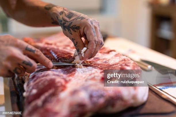 big piece of iberian bacon on a wooden board - adding salt stock pictures, royalty-free photos & images