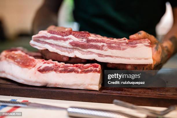big piece of iberian bacon on a wooden board - ribs on board - fotografias e filmes do acervo