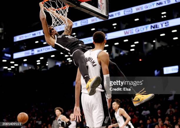 Nic Claxton of the Brooklyn Nets dunks over Victor Wembanyama of the San Antonio Spurs in the second half at Barclays Center on February 10, 2024 in...