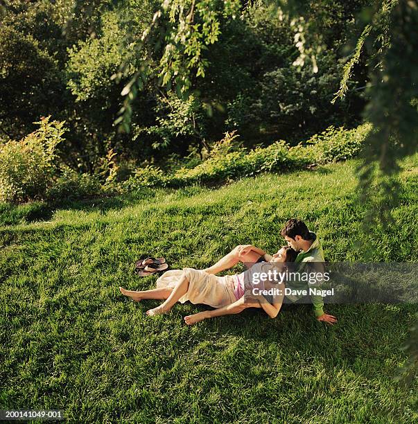 couple lying on grass, elevated view - mid distance stock pictures, royalty-free photos & images