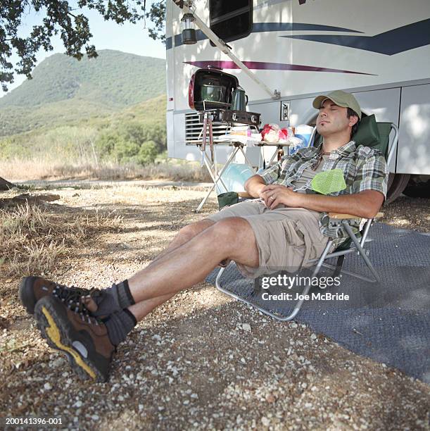 man sleeping in folding chair, rv camping - man sleeping with cap stock pictures, royalty-free photos & images