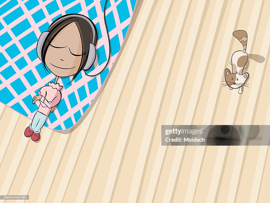 Young woman lying on bed wearing headphones, elevated view