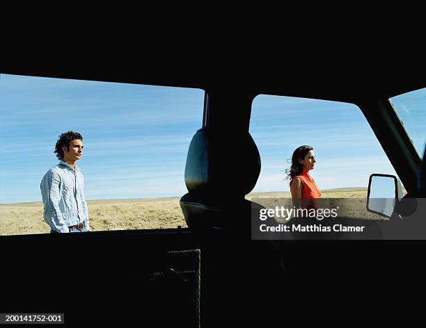 man and woman standing outside van, side view - travel7 stock pictures, royalty-free photos & images