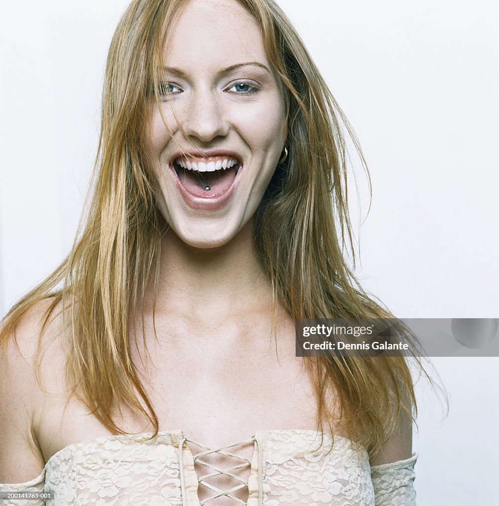 Young woman with pierced tongue