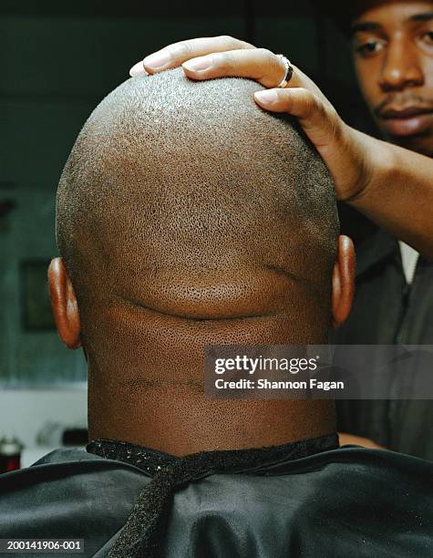 man in barber's chair, rear view, close-up - shaved head stockfoto's en -beelden