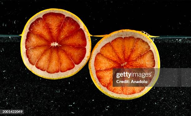 Slices of a grapefruit are seen after splashing in water in Ankara, Turkiye on February 07, 2024.