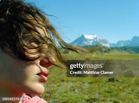 Young Woman With Hair Blowing Across Face Side View Closeup Stock-Foto