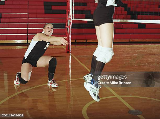 teenage girls (14-16)playing volleyball in gym - girls volleyball stock pictures, royalty-free photos & images