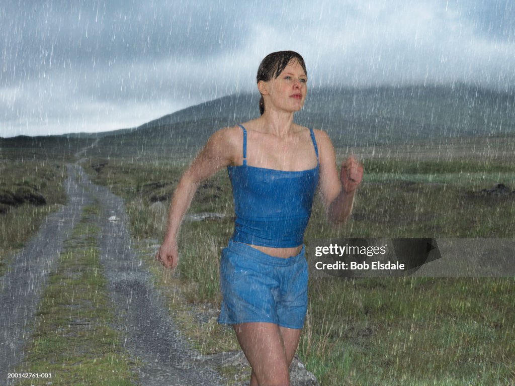 Woman Getting Rained On While Running Woman Jogging In Rain High-Res Stock Photo - Getty Images