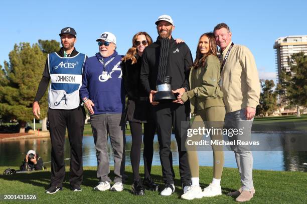 Captain Dustin Johnson of 4Aces GC poses with his family and the individual trophy after winning during day three of the LIV Golf Invitational - Las...