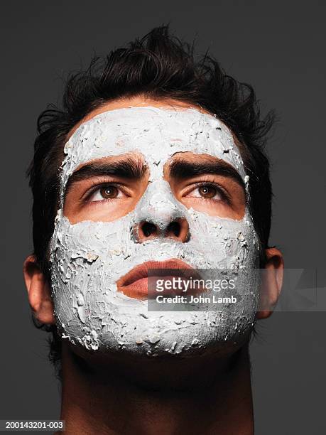 young man wearing face pack, close-up - mask man stock pictures, royalty-free photos & images