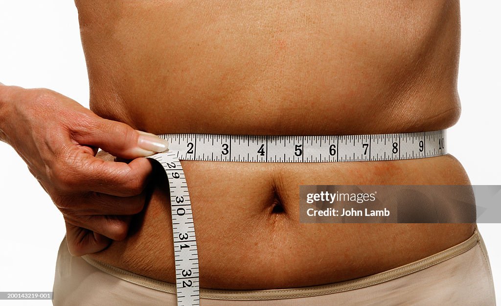 Mature Woman With Tape Measure Around Waist Mid Section High-Res Stock  Photo - Getty Images