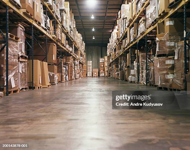 cardboard boxes stacked on shelves in warehouse - storage room stock-fotos und bilder