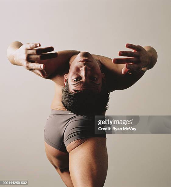 male ballet dancer doing back bend, rear view - contortionist stock pictures, royalty-free photos & images