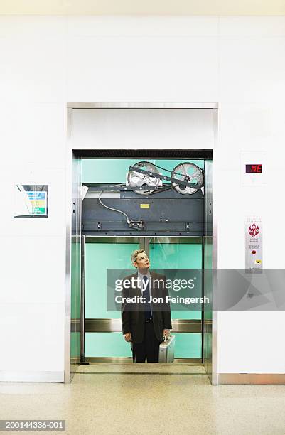 businessman stuck in elevator - wedged stock pictures, royalty-free photos & images