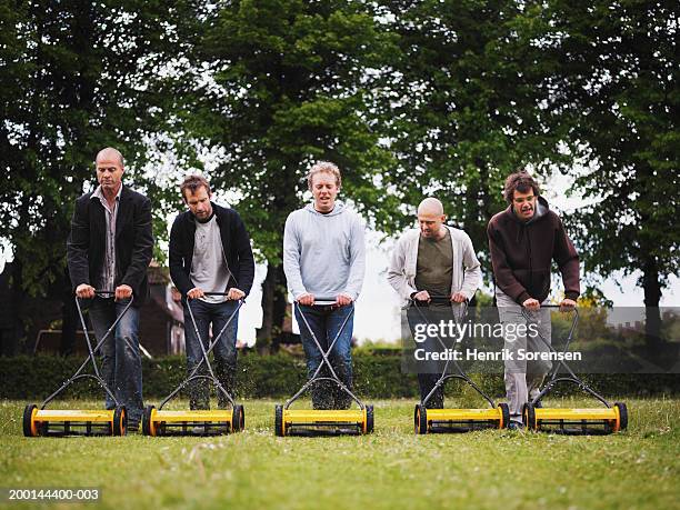 five men mowing lawn in row, looking down - five people stock pictures, royalty-free photos & images