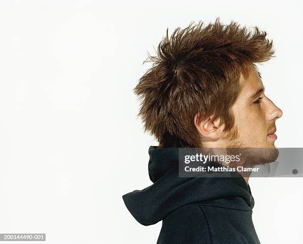 young man wearing hooded sweater, profile, close up - stoneplus4 stock pictures, royalty-free photos & images