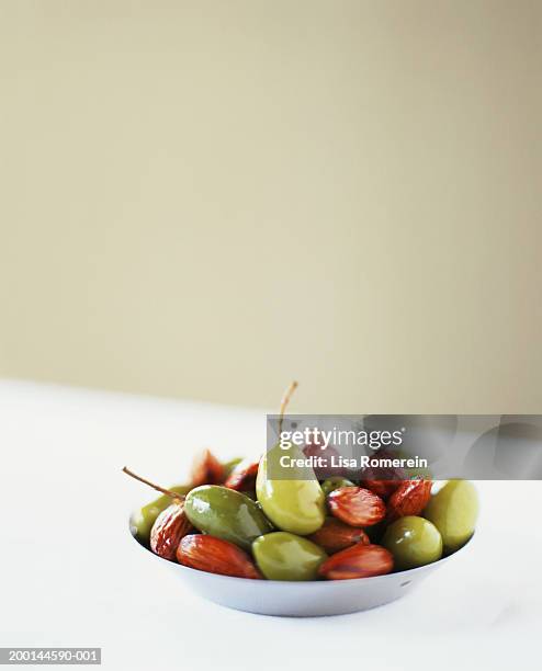 luques olives and almonds in dish - luques olive fotografías e imágenes de stock