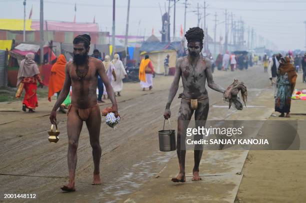 Sadhus or Hindu Holy men return after takin a holy dip at the Sangam, the confluence of the rivers Ganges, Yamuna and mythical Saraswati on the...