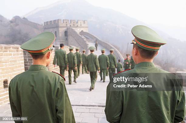 china, badaling, soldiers on the great wall of china, rear view - chinese army stock pictures, royalty-free photos & images